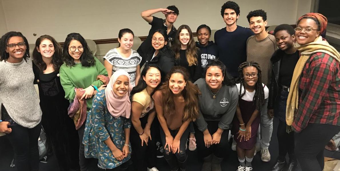 A diverse crowd of students gathers around for a picture.